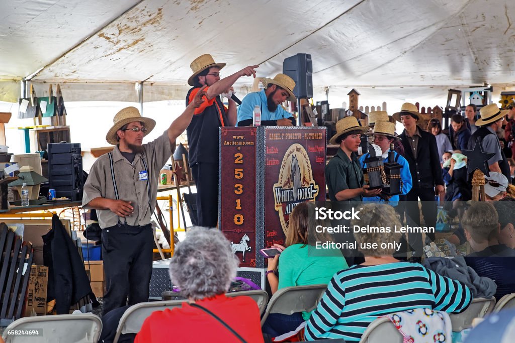 Lancaster County Benefit Auction for Fire Company GAP PENNSYLVANIA - MARCH 25, 2017: Amish volunteers sell art and craft items under a tent at the annual "Amish Mud Sale" to benefit Gap Fire Company. Adult Stock Photo
