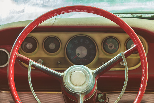 Retro styled image of a weathered dusty interior of a classic car