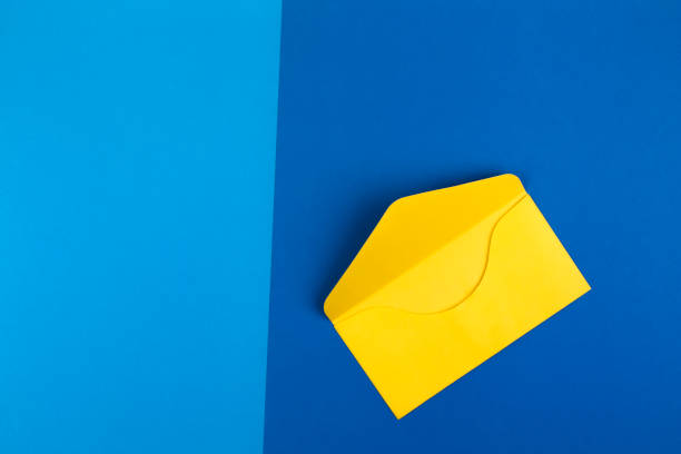 istock Colorful yellow envelope on blue background 658247866
