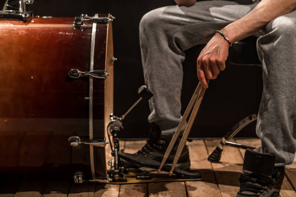 istock man playing the bass drum, wood Board with a black background 658273770