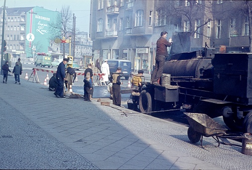 Berlin, Germany, 1965. Roadworks. Workers asphalting a street in Berlin's western part. It was hard work at that time. Berlin kids 