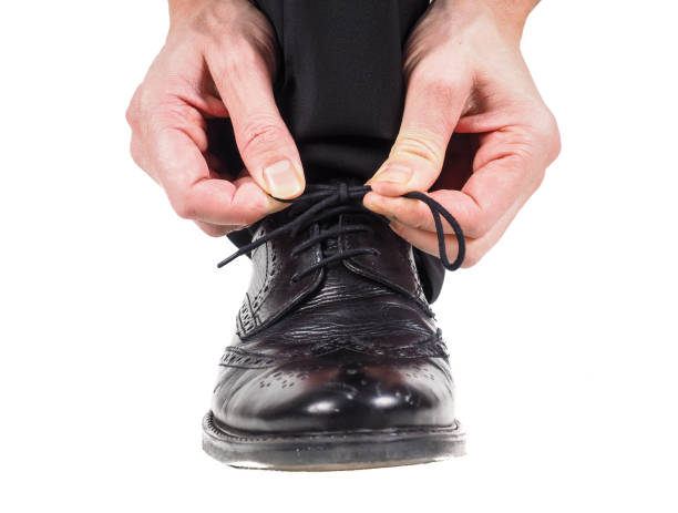 istock Person tying black leather shoes 658277796