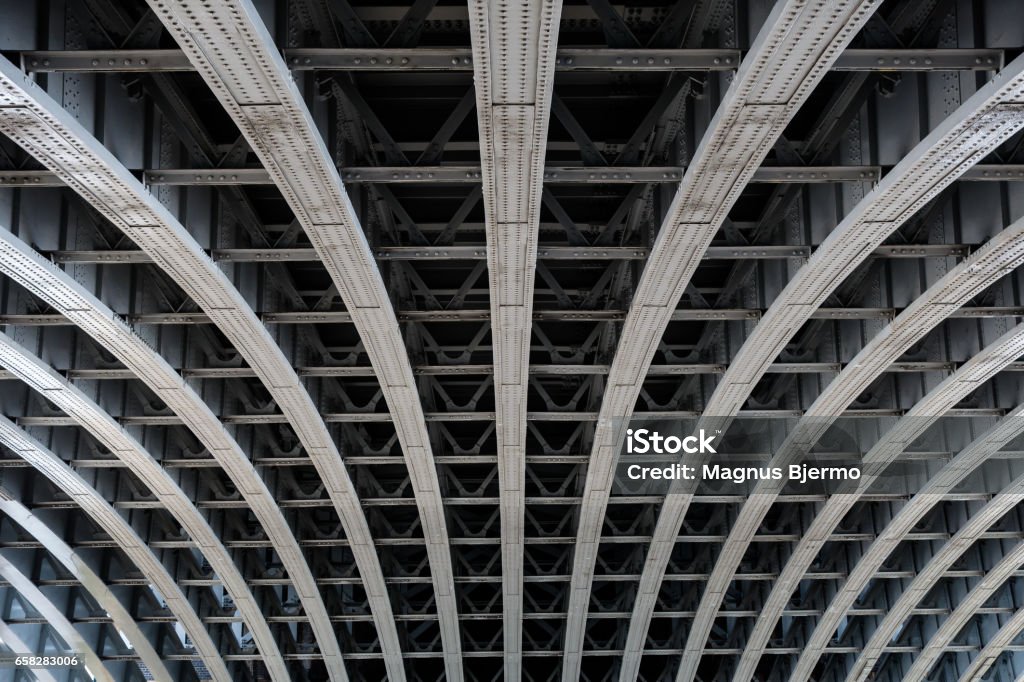 Parallel steel beams supporting bridge span Detail of riveted steel beams supporting span of bridge crossing the River Thames Strength Stock Photo