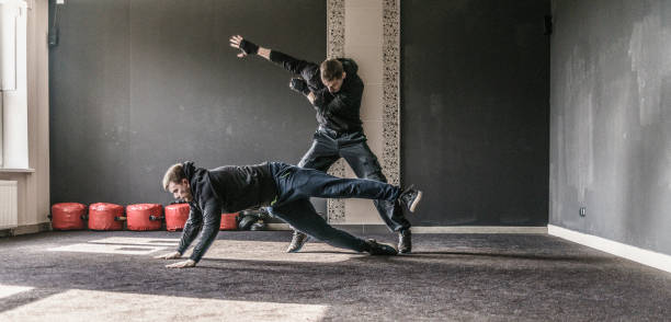 istock The defensive trowing of the attacker. The multi-image sequence with different phases of the single action. Krav Maga practice: the self-defense martial art developed for the Israel Army. Minsk, Belarus. 658297768