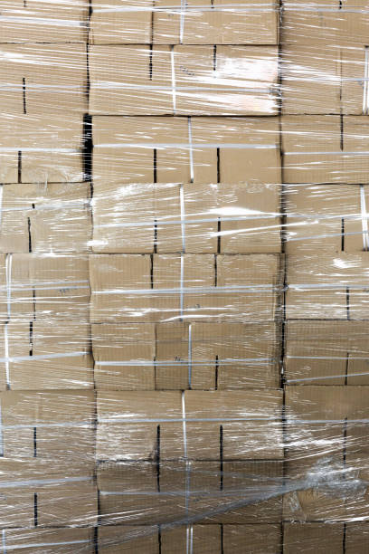 istock Unused paper boxes stacked wrapped by plastic 658307660