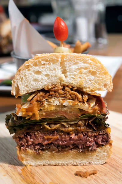istock Half cut hamburger on wooden plate,close up 658308072