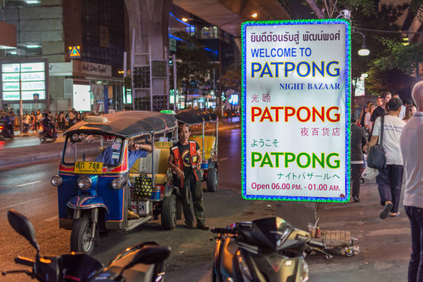Thai TukTuk taxi wait for a tourist on footpath at Patpong night market on silom road internationally tourist popular visited to Patpong. stock photo