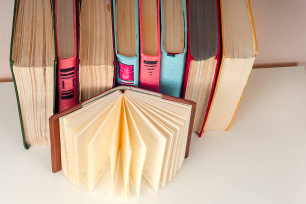 istock Open book, stack of colorful hardback books Back to school. . Education background. 658314686