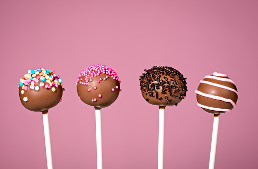 Chocolate cake pops on a pink background