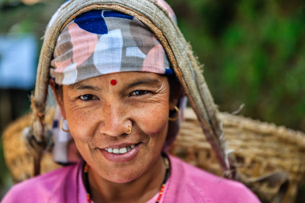 istock Nepali woman carrying a basket near Annapurna Range 658328794