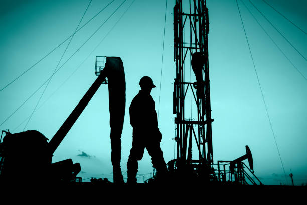 oil field, the oil workers are working oil field, the oil workers are working crane machinery photos stock pictures, royalty-free photos & images