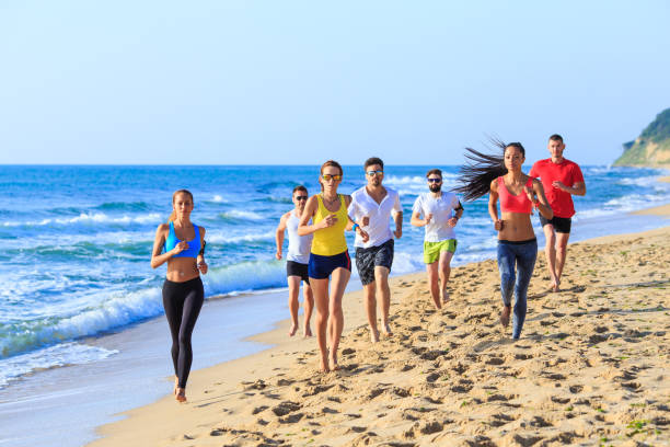 istock Sports team jogging on beach 658359238