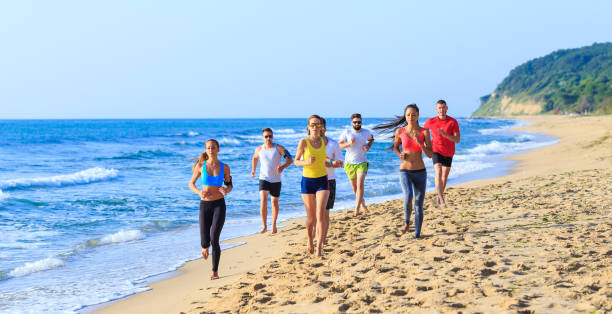 istock Jogging with friends on beach 658359286