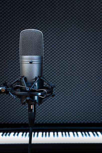 istock condenser microphone on piano background in recording studio 658360224