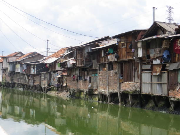 Slum area in Jakarta. JAKARTA, INDONESIA - February 7, 2017: Slum area on the riverbank of Petojo. jakarta slums stock pictures, royalty-free photos & images