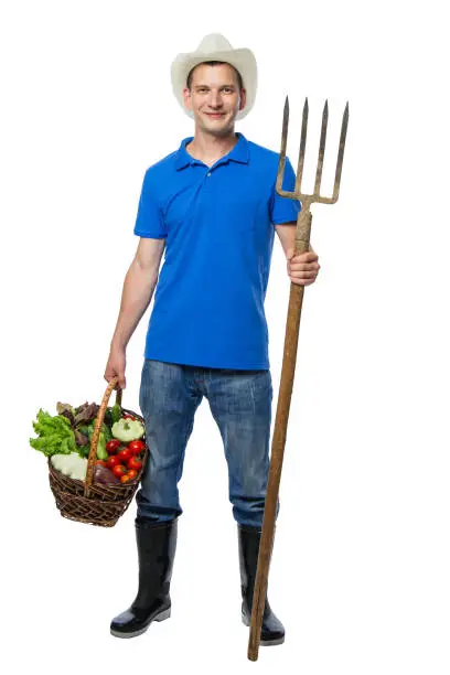 Farmer with forks collected fresh vegetables