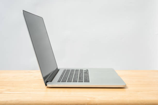 istock Laptop on wood desk with white wall background 658381232
