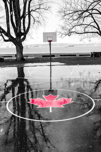 Kitsilano Beach Park courts. Kitsilano, outdoor public basketball court, in Back and white with a maple leaf in the center court in red.