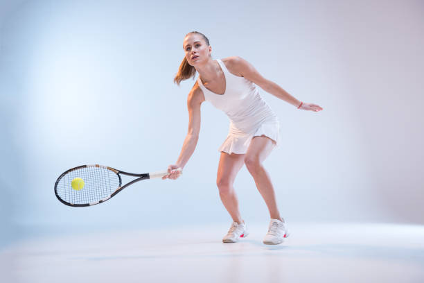 istock Young woman playing tennis 658391082