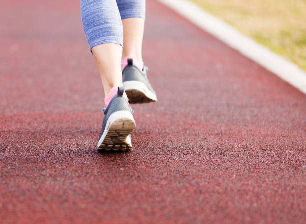 istock Woman running in urban park 658392082