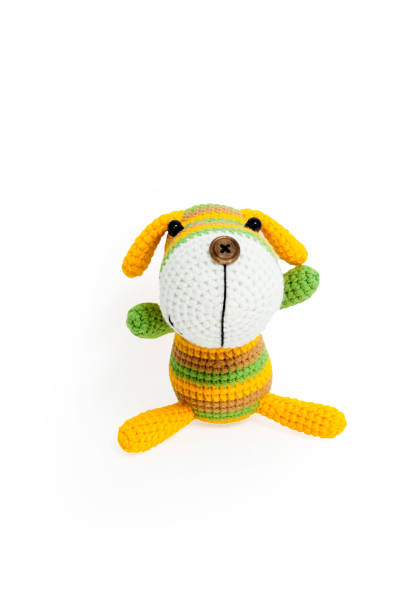 istock Knitted toy - striped sitting dog. 658396758