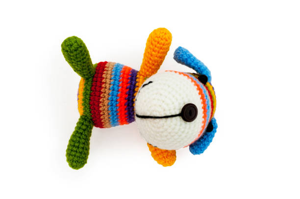 istock Knitted toy - striped lying dog. 658396776
