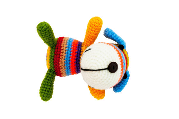 istock Knitted toy - striped lying dog. 658396814