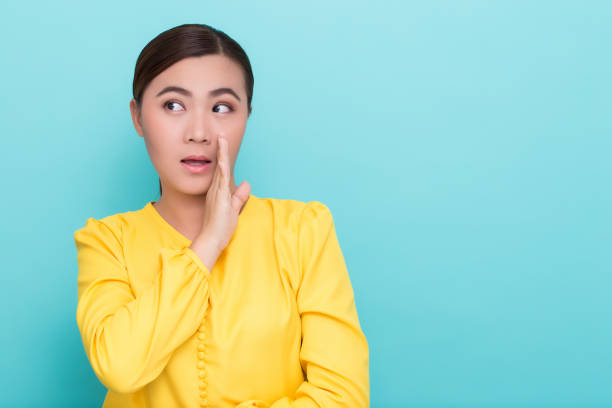 istock Happy asian woman make the gossip gesture 658400098
