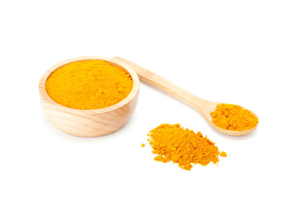 istock turmeric powder in wooden bowl 658400478