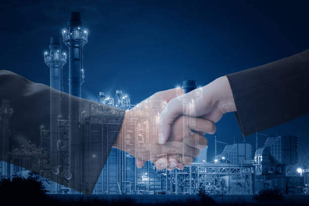 istock businessman handshake on industrial blue color tone background. 658400582
