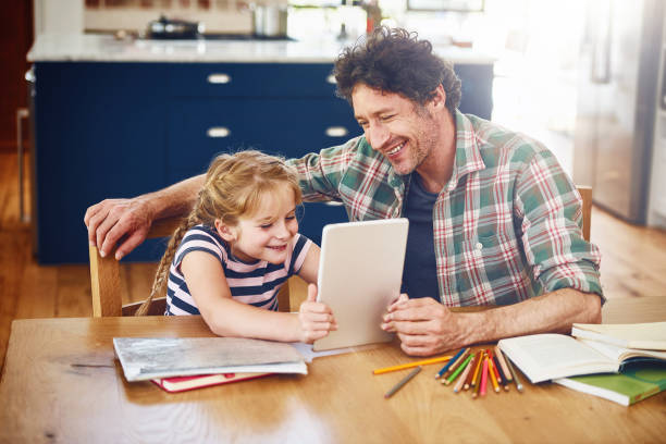 istock Dad's giving her a lesson through the online world 658401360