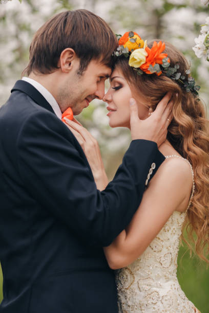 istock Young bride and groom in a lush garden in the spring. 658405380