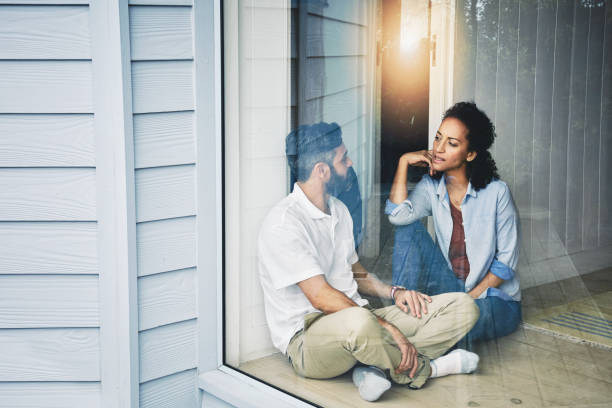 Cosy weekend chats Shot of a relaxed couple enjoying the day at home together serious talk stock pictures, royalty-free photos & images