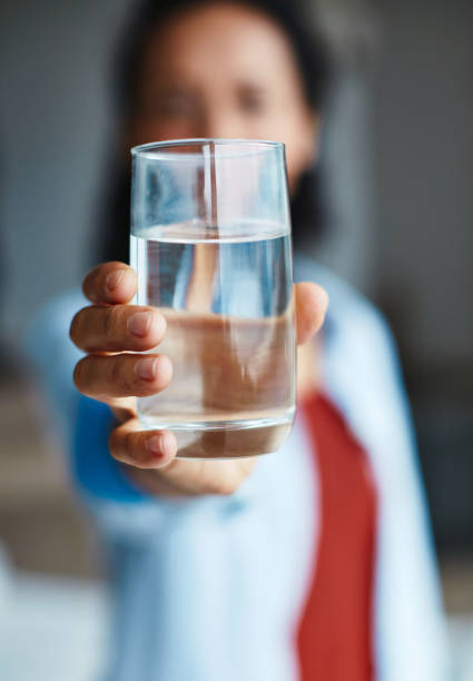 Just add water Shot of a woman drinking a glass of water at home drinking water stock pictures, royalty-free photos & images