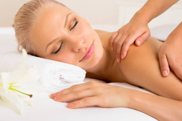 istock Beautiful young woman with eyes closed getting massage 658418806