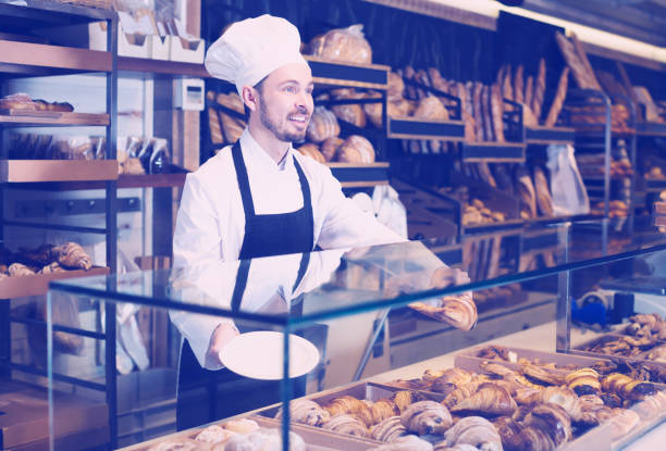 istock Male pastry maker demonstrating beautiful croissant 658421780