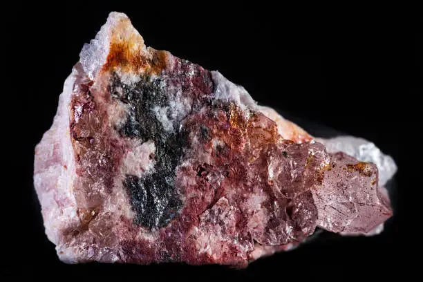 Rhodochrosite mineral on a black background.