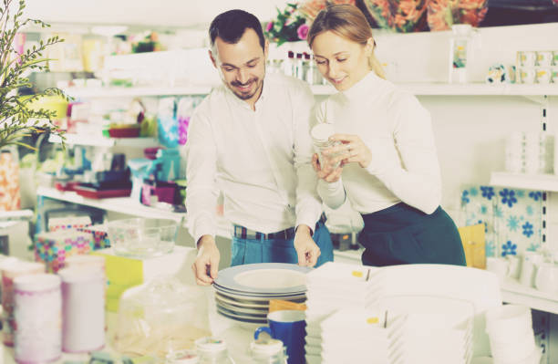 istock Couple choosing new crockery in dinnerware store 658429600