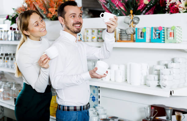 istock Couple choosing new crockery in dinnerware store 658429606