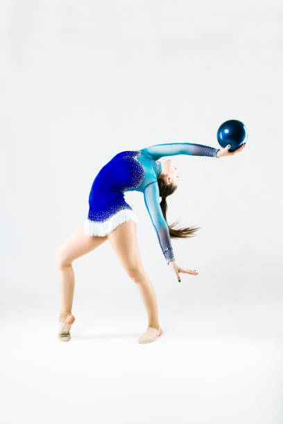 istock Beautiful gymnast athlete doing exercise with ball. Isolated on white. 658430410