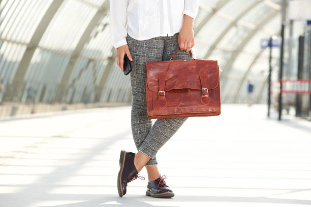 istock woman holding leather bag and mobile phone 658430920