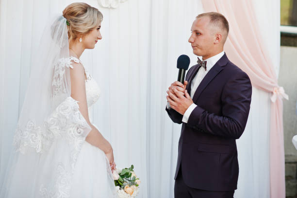 istock Groom speech, talking with microphone for his bride at wedding ceremony. 658431328