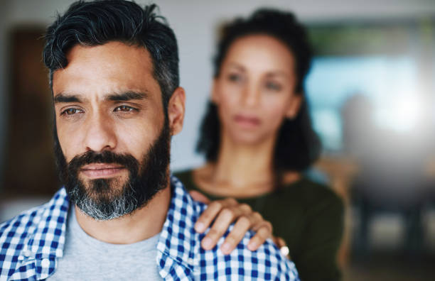 Don't keep it all bottled up Shot of a woman comforting her distraught husband at home Dont stock pictures, royalty-free photos & images