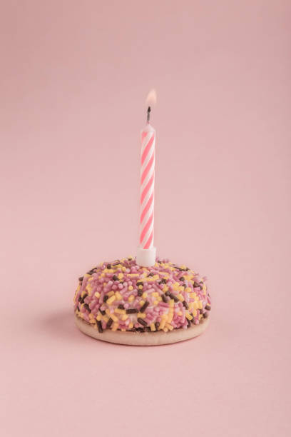 istock birthday cake with one candle on pink 658443542