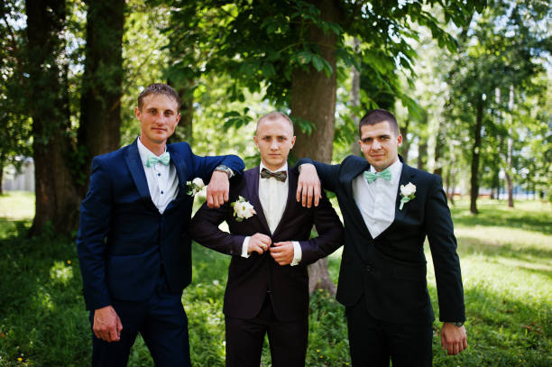 istock Groom with his best man's on wedding at park. 658447168