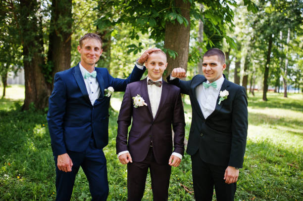 istock Groom with his best man's on wedding at park. 658447170