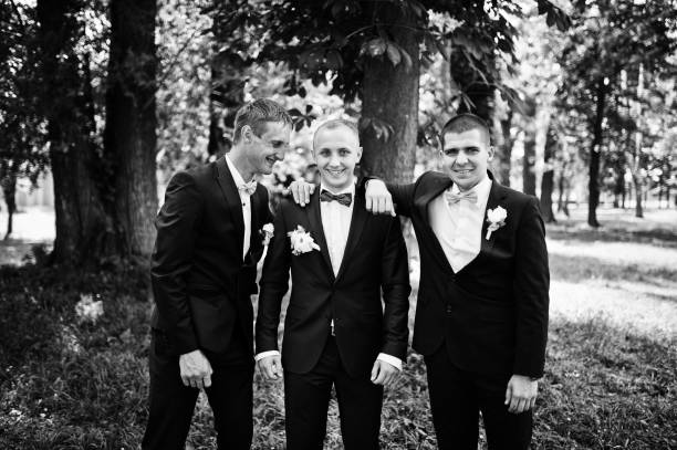 istock Groom with his best man's on wedding at park. 658447260