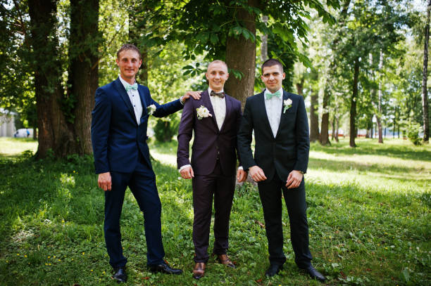 istock Groom with his best man's on wedding at park. 658447264