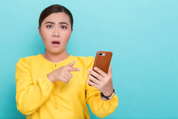 istock Woman look at smartphone and she shocked 658448916