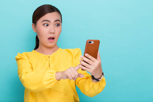 istock Woman look at smartphone and she shocked 658448964